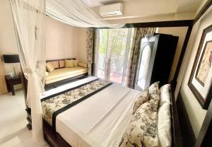 a bedroom with a bed and a window at Pico De Loro 2BR Carola B Unit with Lagoon View in Nasugbu