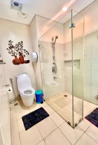 a bathroom with a glass shower and a toilet at Pico De Loro 2BR Carola B Unit with Lagoon View in Nasugbu