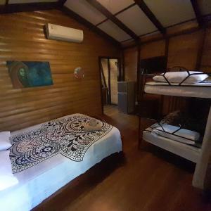 a room with two bunk beds in a house at Hotel Cabinas La Playa in Playa Avellana