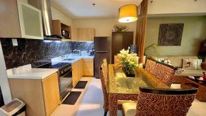 a kitchen with a table and some chairs in a room at Pico De Loro 2BR Carola B Unit with Lagoon View in Nasugbu