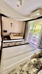 a bedroom with a large bed and a window at Pico De Loro 2BR Carola B Unit with Lagoon View in Nasugbu