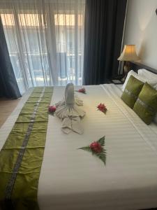 a hotel room with a bed with flowers on it at Blue Bay Resort in Ko Yao Yai