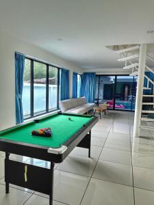 a pool table in the middle of a living room at Mona Lisa pool villa in Pattaya South