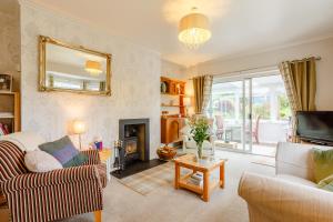 a living room with a couch and a fireplace at Urquhart Bay B&B in Drumnadrochit