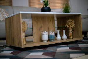 a shelf with vases on it in a living room at Irofo City Apartments in Accra