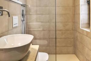 a bathroom with a sink and a shower at Villa Eleonora - Sea view in Santa Teresa Gallura