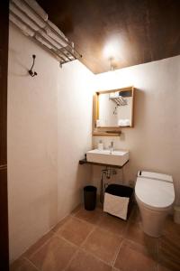 a bathroom with a toilet and a sink at HOTEL Clam Chowder in Kyoto