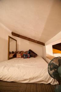 a bedroom with a white bed with a mirror at HOTEL Clam Chowder in Kyoto