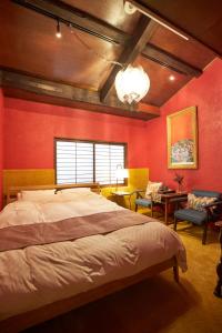 a bedroom with red walls and a large bed at HOTEL Clam Chowder in Kyoto