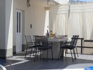 a kitchen with chairs and a table with a counter top at Villa Marina in Omiš