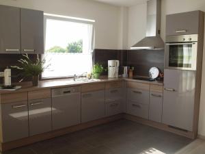 a kitchen with stainless steel appliances and a window at Ferienwohnung Angelika _ Peter Kel in Scharbeutz