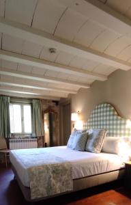 um quarto com uma grande cama branca e tectos em plano aberto em Maison Barón de la Galleta B&B em Quintanilla las Torres