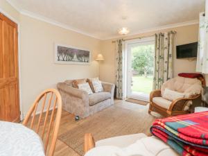 a living room with a couch and a chair at Little Claremont in Yelverton