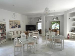 a living room with a white table and chairs at Artemis Hotel in Antiparos