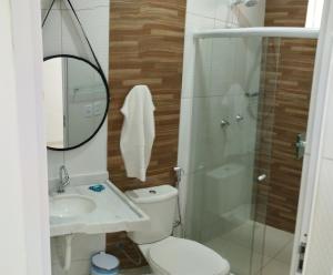 a bathroom with a toilet and a sink and a shower at pousada beira mar suites São Bento in Maragogi