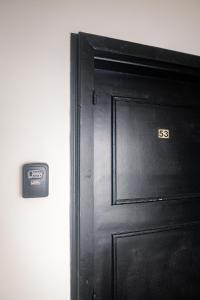 a black door with the number on it at Quattro Beachfront Sea View Ap 53 in Larnaka