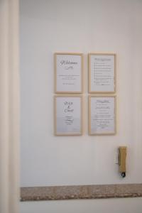 three framed diplomas on a white wall at Quattro Beachfront Sea View Ap 53 in Larnaka
