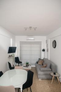 a living room with a couch and a table at Quattro Beachfront Sea View Ap 53 in Larnaka