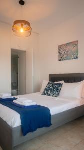 a bedroom with a large bed with a blue blanket at Quattro Beachfront Sea View Ap 53 in Larnaka