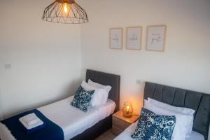 a small bedroom with two beds and a lamp at Quattro Beachfront Sea View Ap 53 in Larnaka