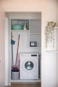 a laundry room with a washing machine in a room at Quattro Beachfront Sea View Ap 53 in Larnaka