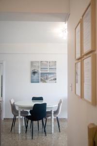 a white table and chairs in a room at Quattro Beachfront Sea View Ap 53 in Larnaka