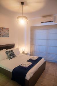 a bedroom with a bed with a blue wall at Quattro Beachfront Sea View Ap 53 in Larnaka