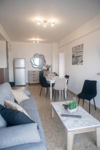 a living room with a couch and a table at Quattro Beachfront Sea View Ap 53 in Larnaka
