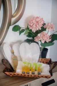 a basket with drinks and a vase with pink flowers at Quattro Beachfront Sea View Ap 53 in Larnaka