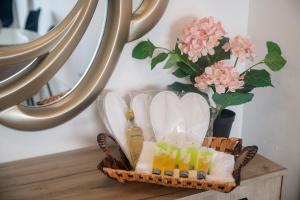a basket of towels and drinks on a table with a mirror at Quattro Beachfront Sea View Ap 53 in Larnaka