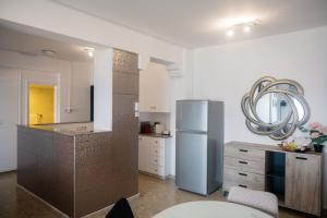 a kitchen with a refrigerator and a table in it at Quattro Beachfront Sea View Ap 53 in Larnaka