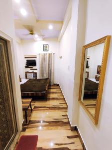 a hallway with a mirror and a living room at Bhagyashree Guest House in Varanasi
