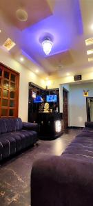 a living room with couches and a tv in a room at Bhagyashree Guest House in Varanasi