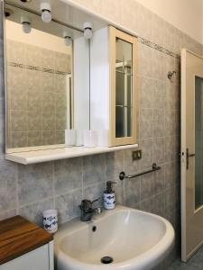 a bathroom with a sink and a mirror at Casa Emma 400 mt dal mare in Spotorno