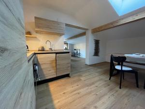 a kitchen with a counter and a table in a room at Bartmann Ferienwohnungen in Ramsau