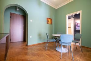 a room with a table and chairs and a purple door at Athens armonia 2 bedrooms 4 pers. apartment by MPS in Athens