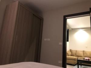 a bedroom with a bed and a mirror and a couch at Lovely studio in the heart of heliopolis, cairo in Cairo +5 photos