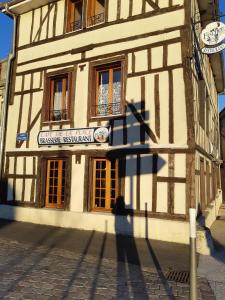 a shadow of a person standing in front of a building at Le Nid in Éclaron