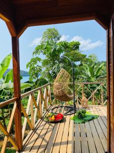 a balcony with a basket and fruits on a table at Valdivia Homes -Príncipe in Santo António