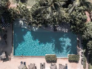 an overhead view of a swimming pool with palm trees at Barcelo Coconut Island, Phuket in Phuket