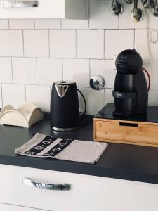 a black coffee maker sitting on a counter in a kitchen at Casa Emma 400 mt dal mare in Spotorno