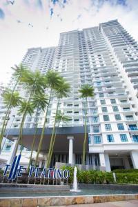 um grande edifício branco com palmeiras em frente em Paradigm Mall Platino Apartment 2BR 2FREE By Natol em Johor Bahru