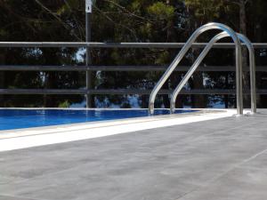 a metal railing next to a swimming pool at Villa Marina in Omiš