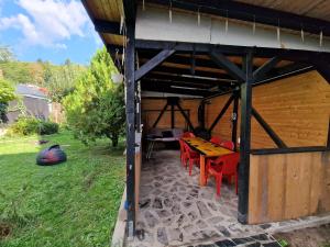 a patio with a table and chairs in a building at Sabina's Cozy House in Buşteni