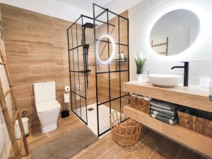 a bathroom with a toilet and a sink and a mirror at NEWQUAY in Playa de las Americas +22 photos