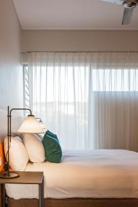 a bedroom with a bed with a window at Smiths Beach Resort in Yallingup