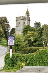 a sign on the side of a road in front of a castle at The Old Bell in Wooburn