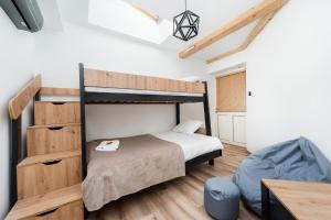 a bedroom with a bunk bed and a desk at WAWELOFT APARTMENT in Kraków