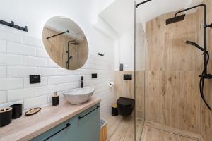 a bathroom with a sink and a shower at WAWELOFT APARTMENT in Kraków +40 photos