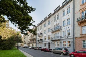 a row of buildings on a street with parked cars at WAWELOFT APARTMENT in Kraków